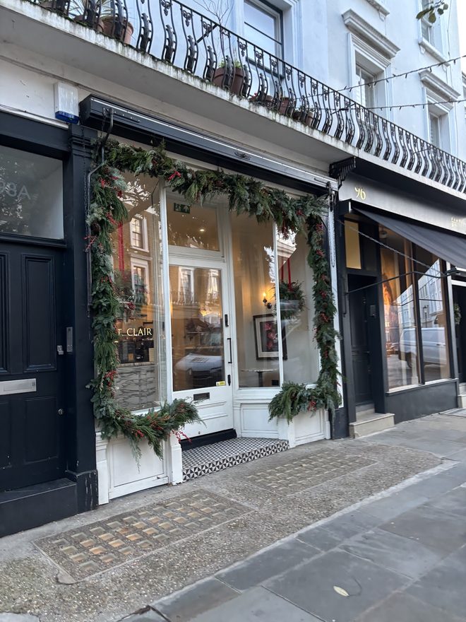 The dark shopfront and its windows from across the pavement.