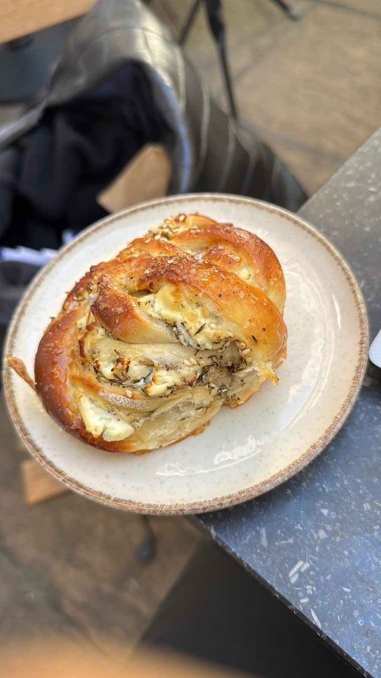 A cheese and herb scone on a small plate.